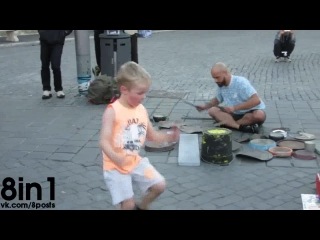 a teen boy dances heartily during a performance by famous street drummer dario rossi / dario rossi street drummer